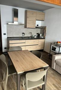 a kitchen with a table and chairs in a room at Casa Vacanza in Prato Nevoso