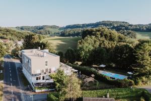 an aerial view of a house with a swimming pool at Ewitsch 13 - Hotel Garni in Berghausen