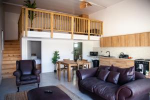 a living room with a couch and a table at The Boathouse in Yzerfontein