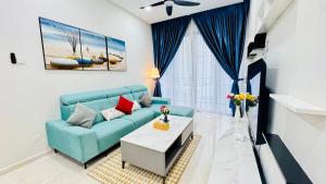 a living room with a blue couch and a table at Panorama Suites at Manor Kuala Lumpur in Kuala Lumpur