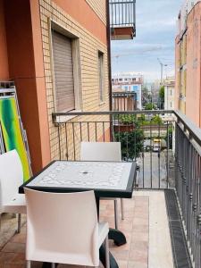 a table and chairs on the balcony of a building at Mare e dintorni in San Benedetto del Tronto