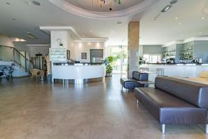 a lobby with couches and a bar in a building at Hotel Bellevue in Cattolica