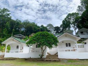 a white house with a tree in front of it at Private Paradise Resort in Ko Chang