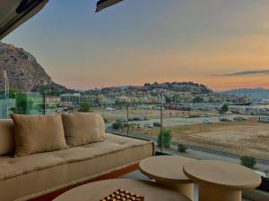 a living room with a couch and a view of a city at FOS Luxury Apartment with View of Nafplio in Nafplio