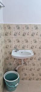 a bathroom with a sink and a toilet at Grace Cottage in Ooty