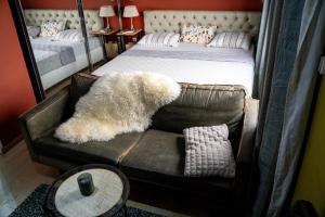a bedroom with a bed and a chair with a teddy bear at Woro Ladia in Conakry