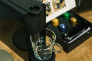 a glass is being poured into a coffee machine at GOOD DAY Shinagawa HOTEL in Tokyo