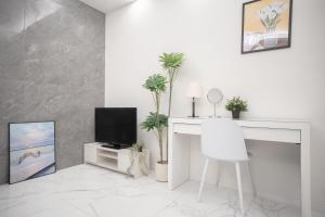 a white living room with a tv and a desk at Brand New Luxury Suite 7 min to Omotesando 2 min to Shibuya in Tokyo