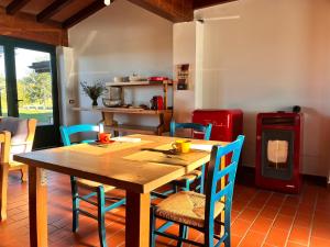a dining room with a wooden table and chairs at Il Cortile Agriturismo in Borgonovo Val Tidone +12 photos