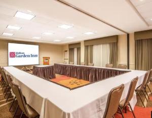 a conference room with a long table and chairs at Hilton Garden Inn Wichita Airport in Wichita