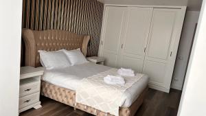a small bedroom with a bed and white cabinets at RoMy'sHome in Târgu Ocna +25 photos