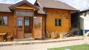 a log cabin building with a store in it at La dolce vita in Inđija