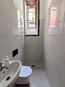 a white bathroom with a sink and a toilet at Comfortable Room in Historic Casa Quesada Shared House in Las Palmas de Gran Canaria