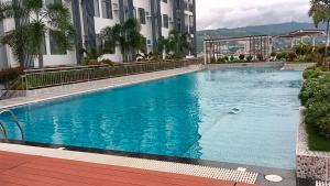 a large blue swimming pool in front of a building at Arc Tower Condominium 1817 in Cebu City