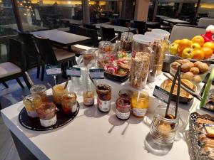 a table with a buffet of food and drinks at Brit Hotel Confort Rouen Centre in Rouen +18 photos
