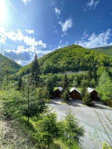 a group of cottages in front of a mountain at Villa Gryka in Peje
