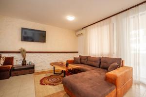 a living room with a couch and a table at Holiday home with indoor fireplace in Pamporovo