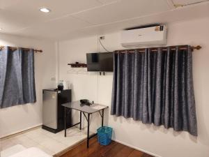 a room with black curtains and a small table at Private Paradise Resort in Ko Chang