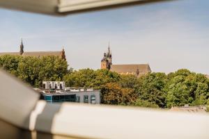a view from a window of a building with trees at Azure Palace - LoftAffair Collection in Kraków