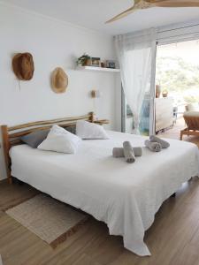 a bedroom with a large white bed with towels on it at Thegoldsand Cala Salions Tossa de Mar in Tossa de Mar