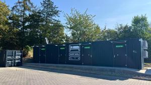 a cluster of green portable toilets sitting next to trees at Roatel Wolfhagen A44 my-roatel-com in Wolfhagen