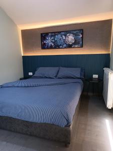 a bedroom with a bed with a painting on the wall at Mountscape in Bmahrāy +34 photos