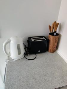 a counter with a toaster and a toaster and a blender at JP Apartment Floor 2 in Grindsted