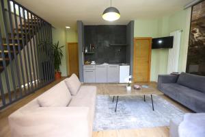 a living room with a couch and a table at Mountscape in Bmahrāy