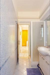 a bathroom with a sink and a toilet and a hallway at Youhome Millelire Apartment in Milan +151 photos