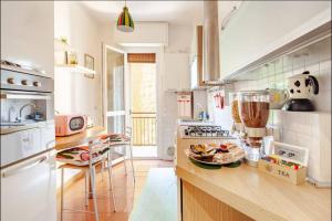 a kitchen with a counter with a plate of food on it at Youhome Millelire Apartment in Milan