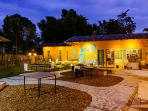 a house with a painting on the side of it at Madcap A Mudhouse Retreat in Palāhu