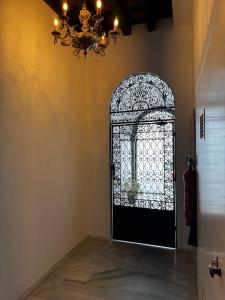 Una habitación con una puerta negra con una lámpara de araña. en Karisma Alcázar, en Jerez de la Frontera