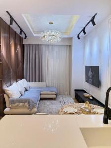 a living room with a couch and a chandelier at AsiaWay Apartment-Tashkent City in Tashkent +42 photos