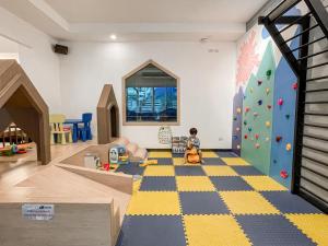 a child playing in a play room with a climbing wall at Kokotel Pattaya South Beach in Pattaya