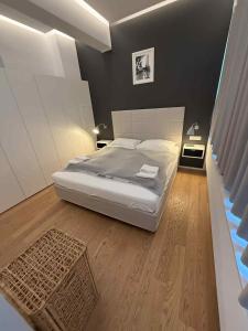 a bedroom with a large bed and wooden floors at Apartmens Libertas in Vienna