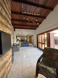 a living room with a couch and a tv at Casa disponível in Ibirubá