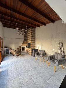 a large living room with couches and a fireplace at Casa disponível in Ibirubá