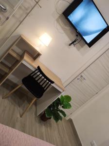 an overhead view of a room with a chair and a television at HOME DOLCE LUNA in Castelvetrano Selinunte