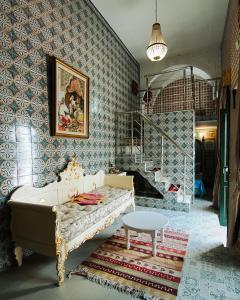a living room with a couch and a table at DAR EL HAMRA in Mahdia