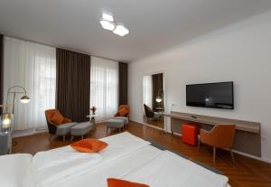 a hotel room with a bed and a flat screen tv at Elias Residence Vienna in Vienna