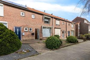 a brick house with a driveway in front of it at Entire Villa, free breakfast, free parking in Veldhoven
