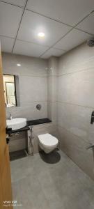a bathroom with a toilet and a sink at The Malay comfort- Hotel Dwarka residency in Dwarka +21 photos
