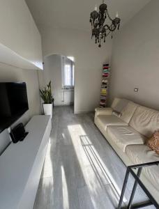 a living room with a couch and a flat screen tv at Casa Dream - Milan in Cesano Boscone