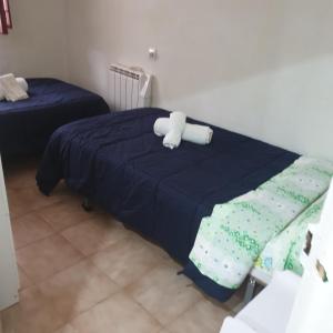 a bed with a teddy bear sitting on top of it at Casita de Aldea in Sotrondio