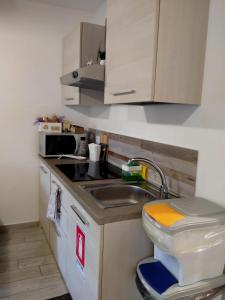 a small kitchen with a sink and a toilet at Il Loft nel Borgo Sospeso "con vista panoramica" in Vitorchiano +30 photos