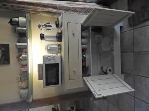 a kitchen with an open door and a stove at Bed&Breakfast 't Eikeltje in Hollandscheveld