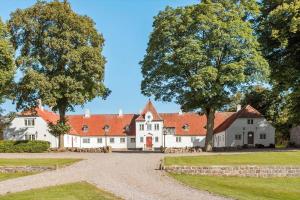 a large white house with a red roof at 84257-Knebel-Snerlevej-7 in Knebel
