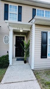 a house with a potted plant in front of a door at Vacay escape, rooms in Charlotte in Charlotte