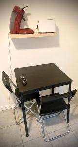 a black desk with a red fire hydrant on a shelf at 15D Vinatier Grange Blanche Bron Essarts in Bron