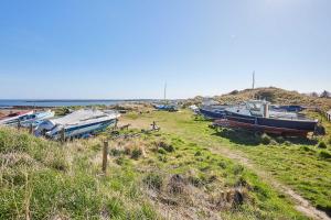 a group of boats sitting in a grassy field at Host & Stay - Spinnaker in Newton-by-the-Sea